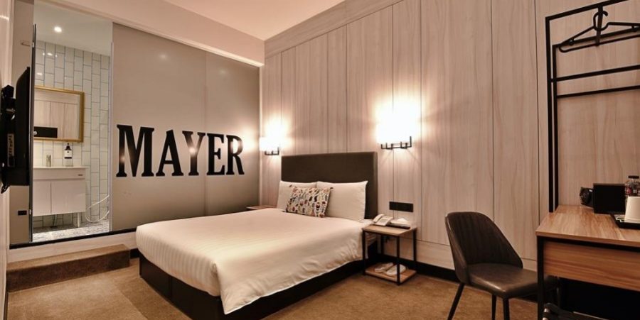 A cozy hotel room with a comfortable bed and a television positioned across from it.